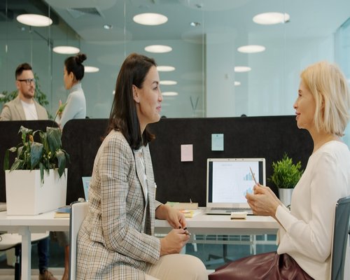Colleagues having a casual chat without screens in a modern workspace
