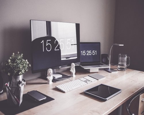 Ergonomic workspace setup with proper monitor distance and warm lighting
