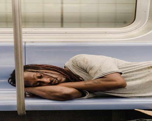 Man resting eyes comfortably on a public transit commute